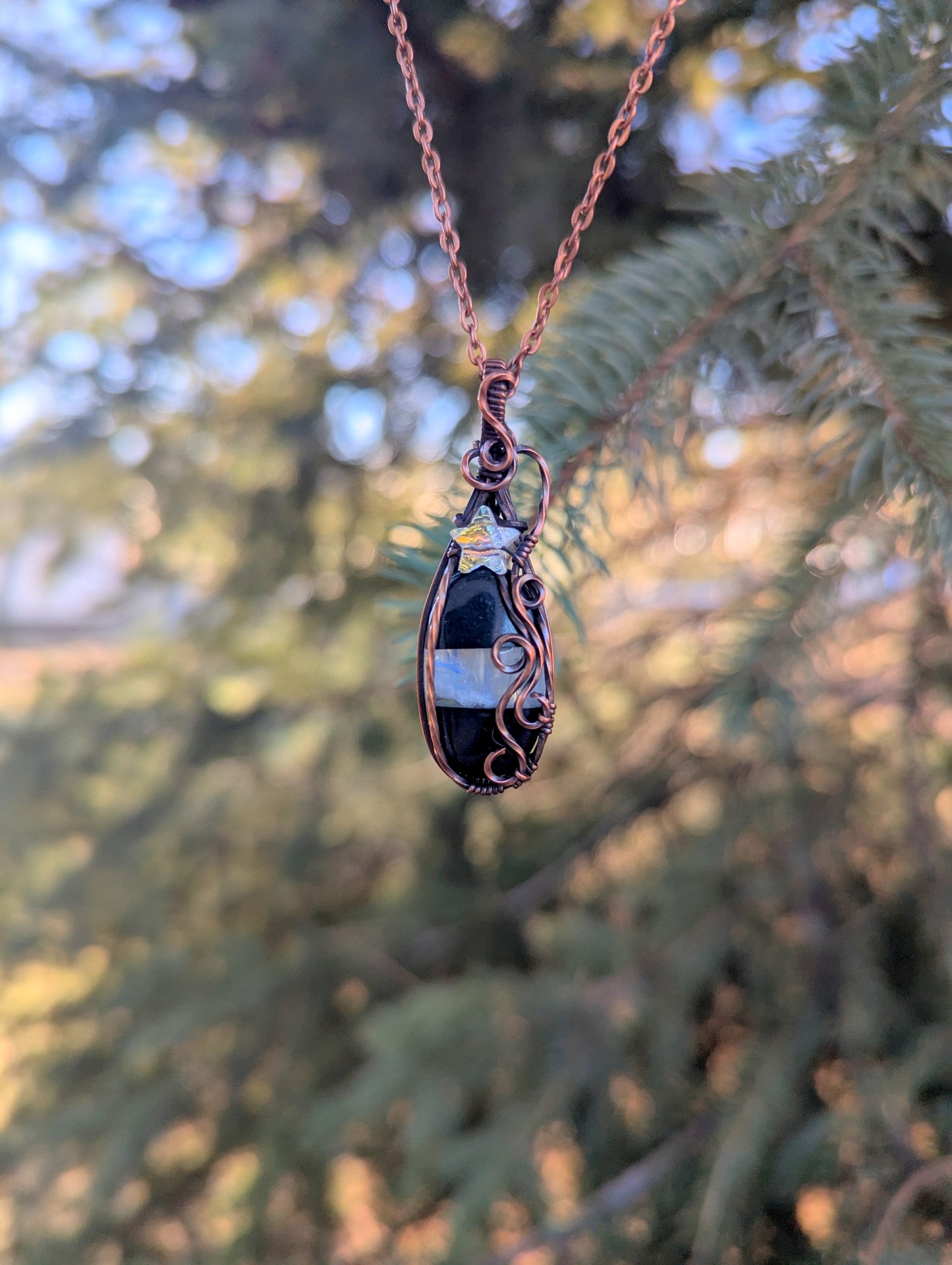 Onyx/moonstone gem pendant - wire wrapped in copper with white star crystal